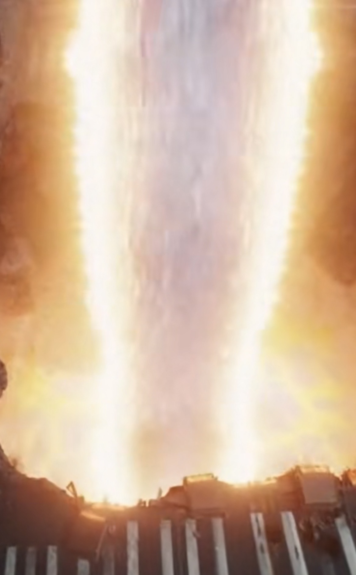 A blazing vertical energy beam striking the ground.