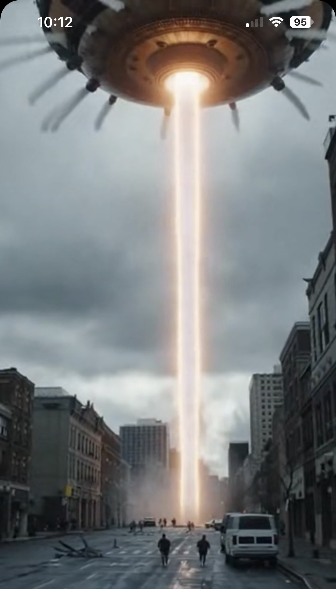 A craft hovering above a city street while projecting a bright beam to the surface.
